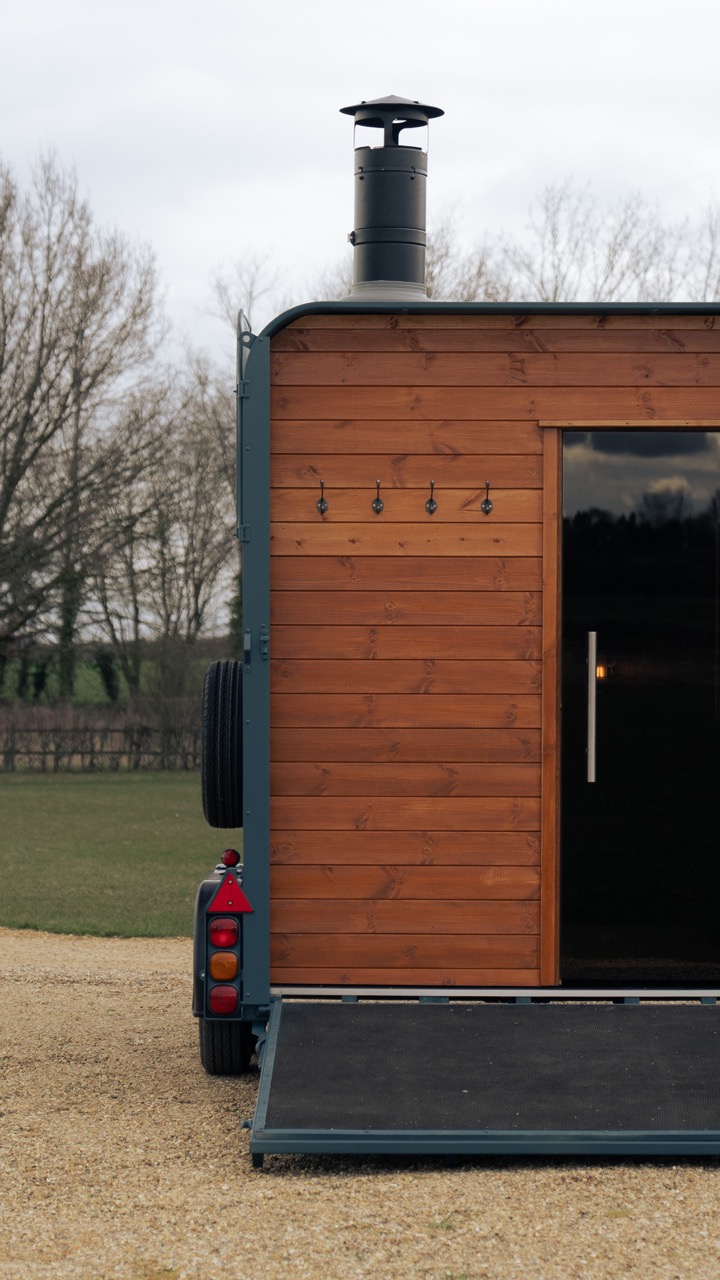 Horsebox sauna exterior, rear view, timber cladding on gravel